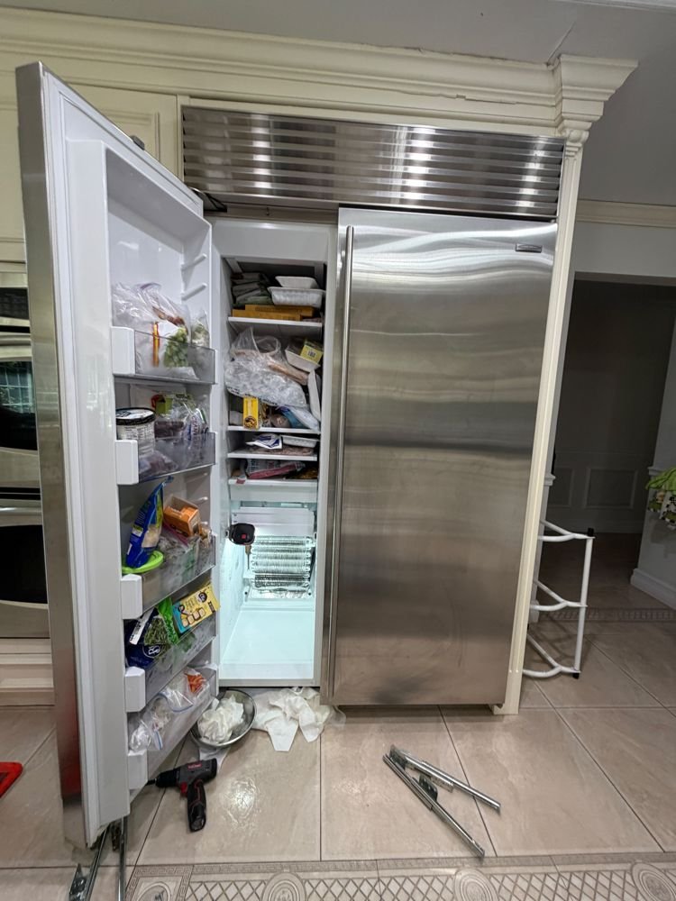 Lankon technician repairing a built-in Sub-Zero refrigerator in Queens NY